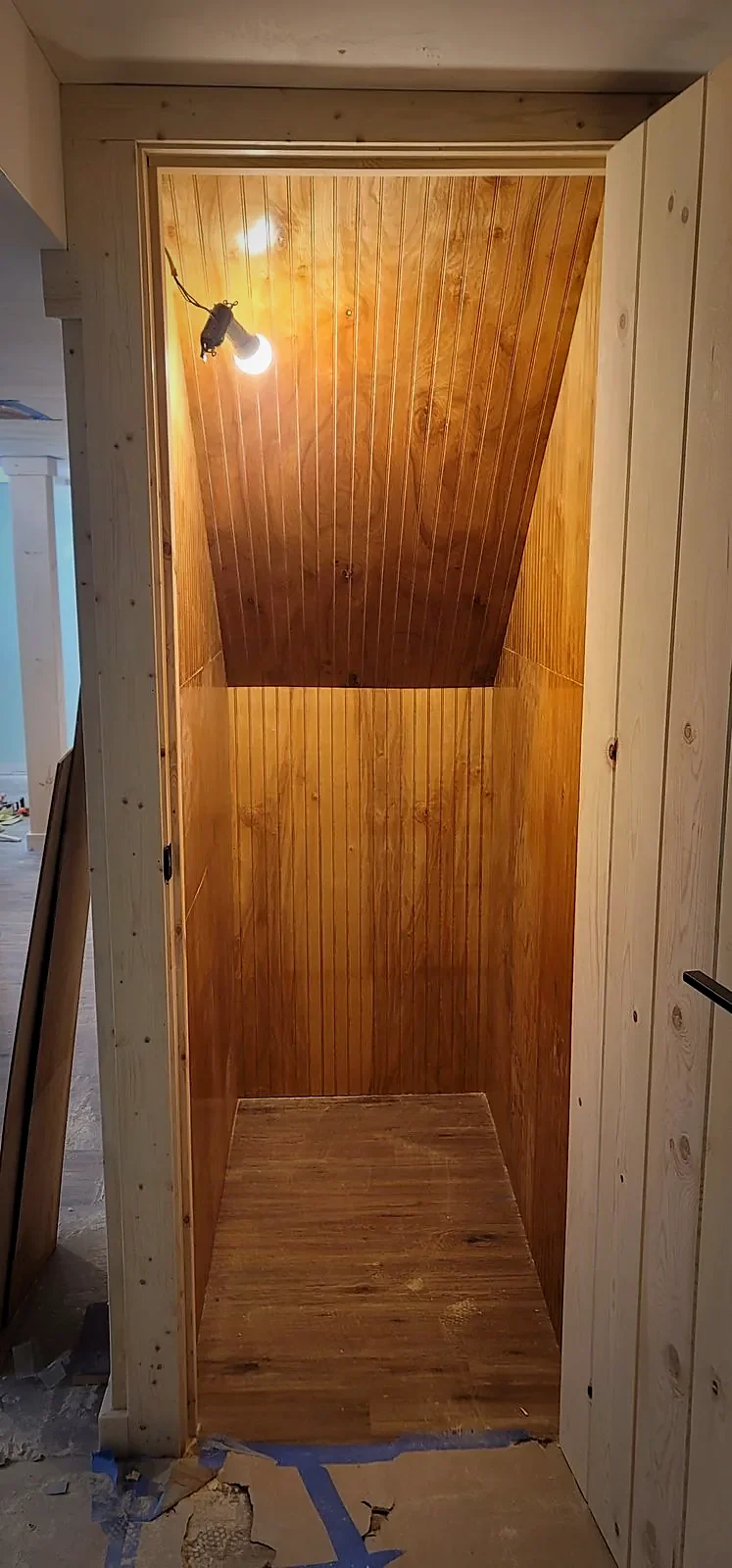 Finished interior of custom under-stair storage closet