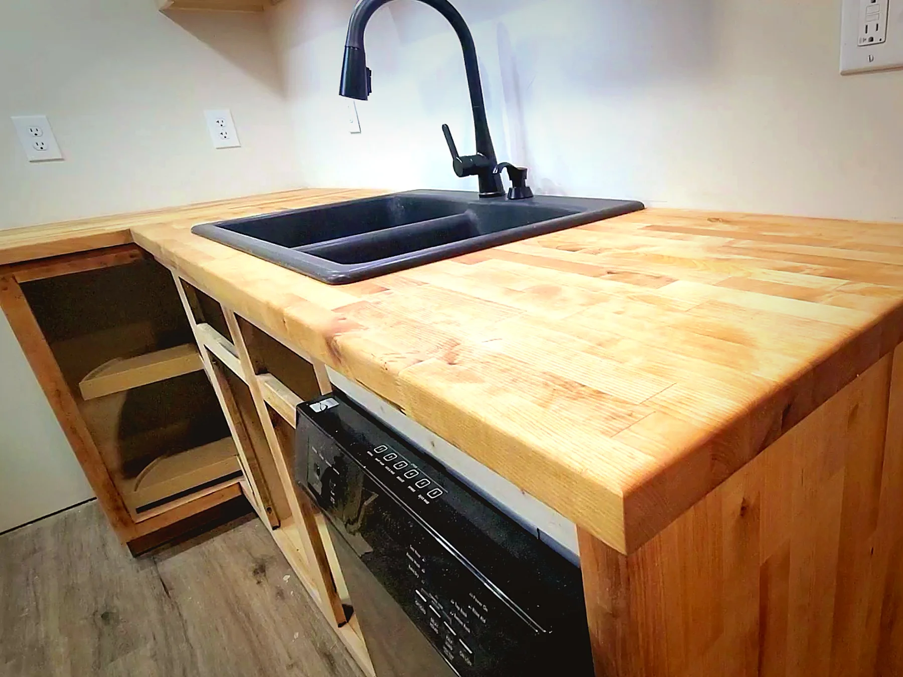 Basement kitchenette with custom butcher block counter and sink