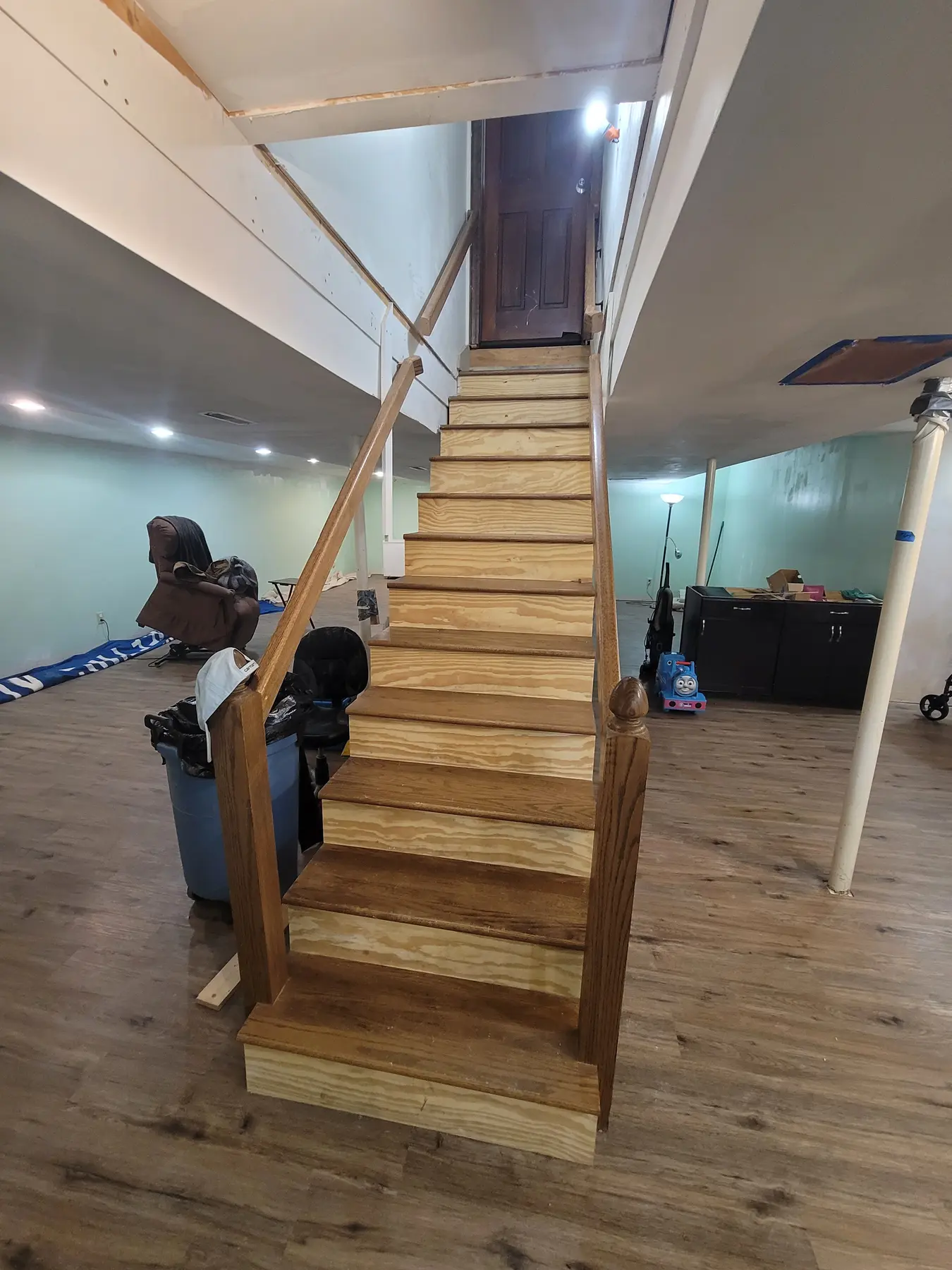 Basement stairwell before the remodel, open framing around the stairs