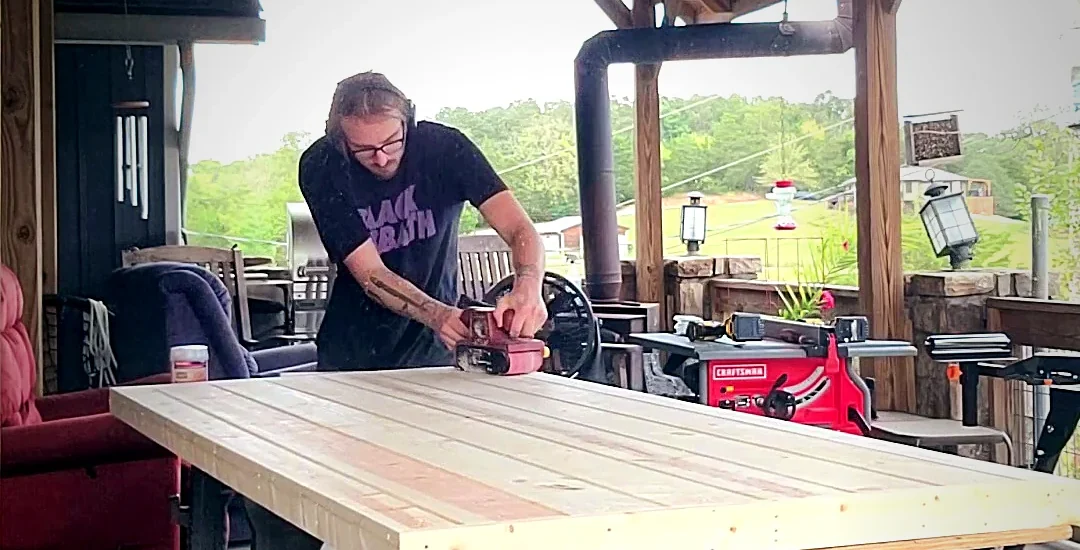 Hayden sanding a custom exterior door panel